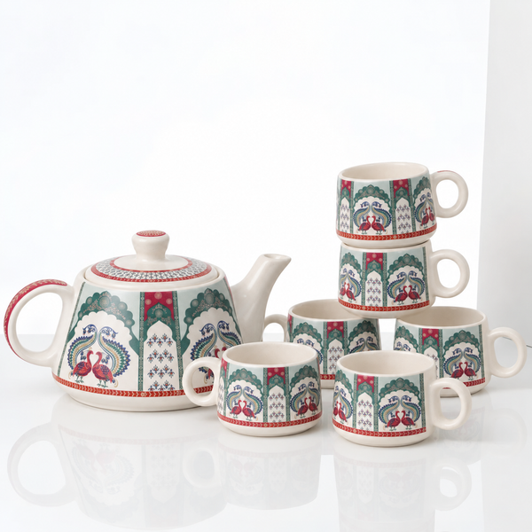 A ceramic tea and coffee mug set with a teapot, including six mugs and a teapot, decorated with a traditional peacock and tree motif in green, red, and blue on an off-white background.