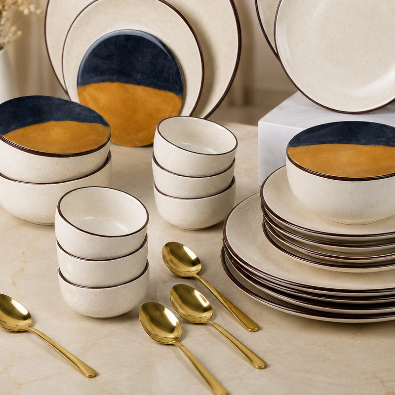 Ceramic dinnerware set with gold accents on a marble surface