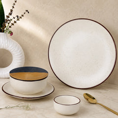 Ceramic tableware set with a bowl, plate, and small cup on a neutral background.
