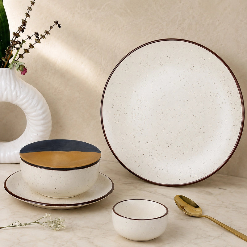 Ceramic tableware set with a bowl, plate, and small cup on a neutral background.