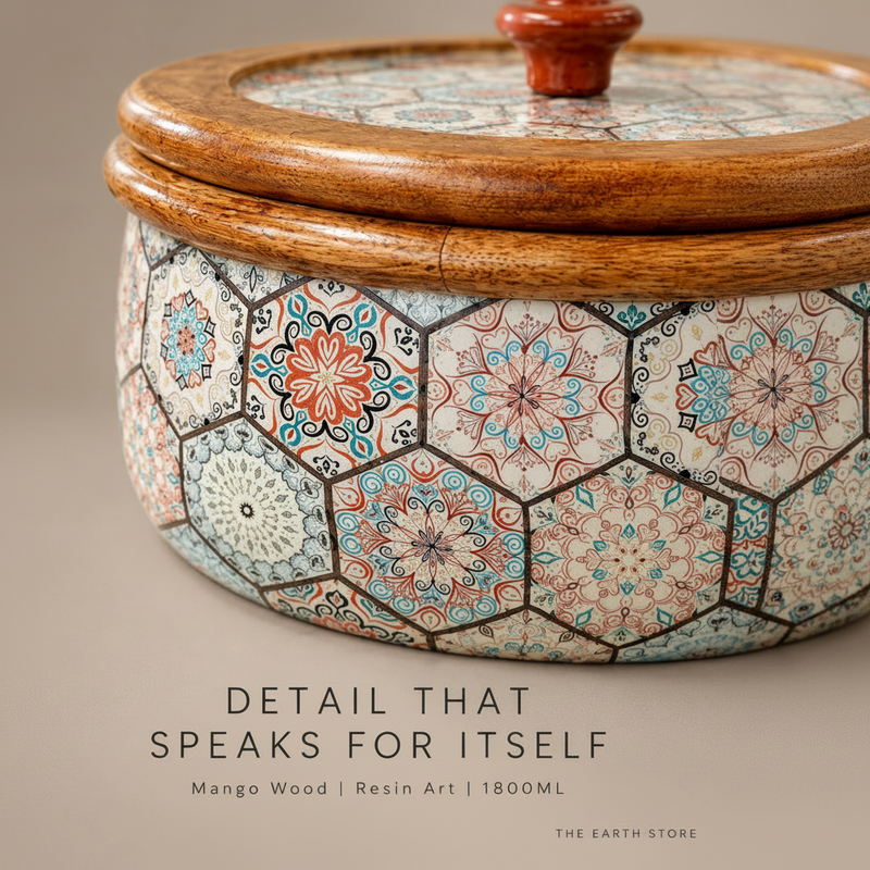 Close-up of a decorative lidded container with a mango wood rim and lid, featuring a hexagonal mosaic tile pattern in beige, blue, orange, and black. Text overlay at the bottom reads 'DETAIL THAT SPEAKS FOR ITSELF' and 'Mango Wood | Resin Art | 180ML'.